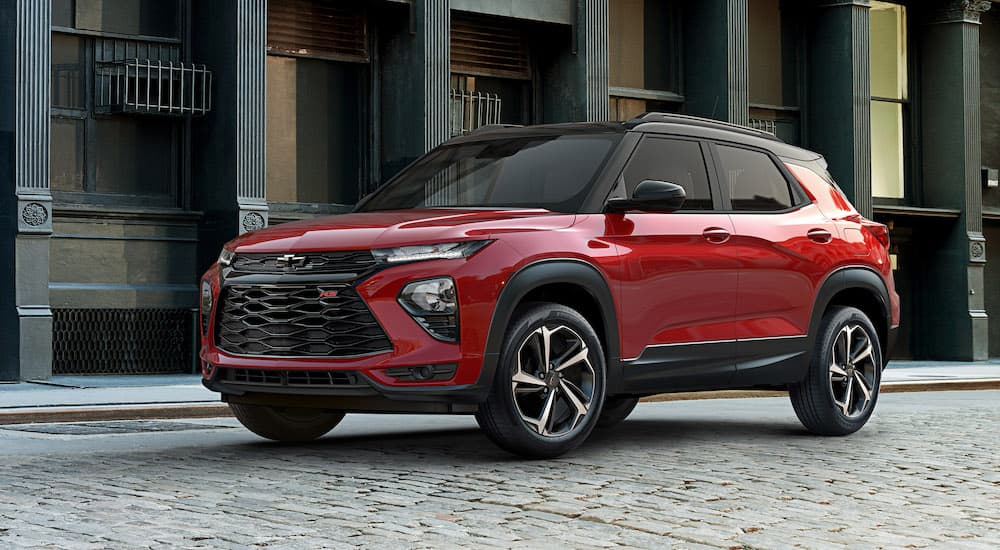 A red 2021 Chevy Trailerblazer is on a city street and will be arriving at Chevy dealerships late 2020.