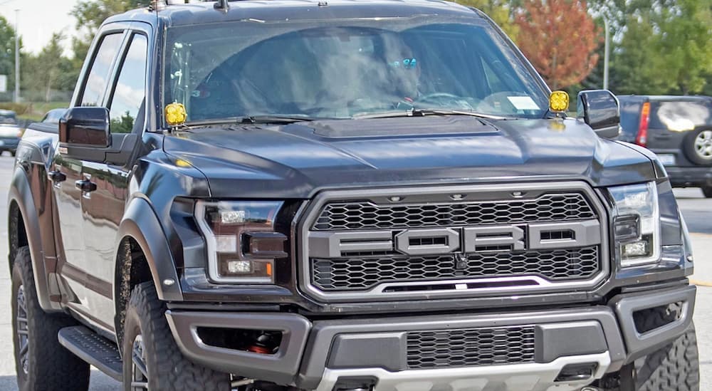 A test 2021 Ford Raptor is driving down a city street.