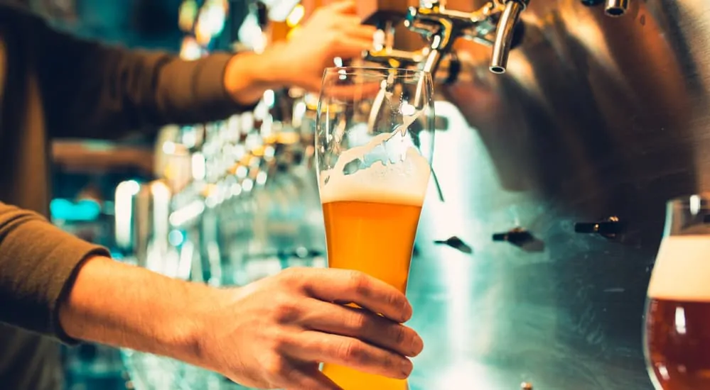 A man is pouring beer into a glass.