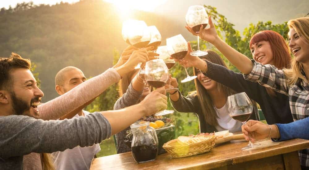 After going to a Chevy dealership near you, you can enjoy wine at a local winery like these friends are. 