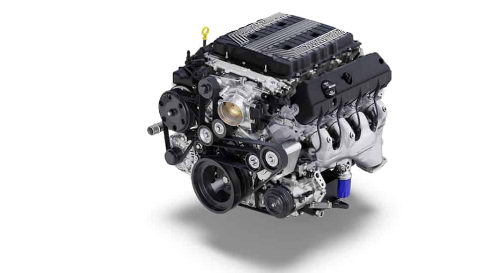 The Supercharged 6.2L LT4 V8 engine that can be found under the hood of a 2020 Chevy Camaro is shown on a white background. 