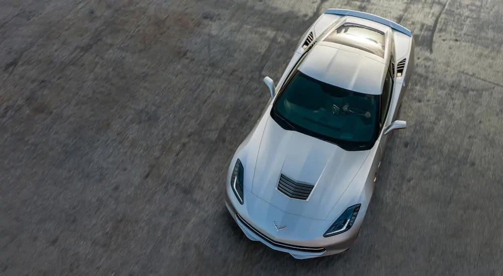 A bird's eye view of a silver 2019 Chevy Corvette parked on a racetrack. 