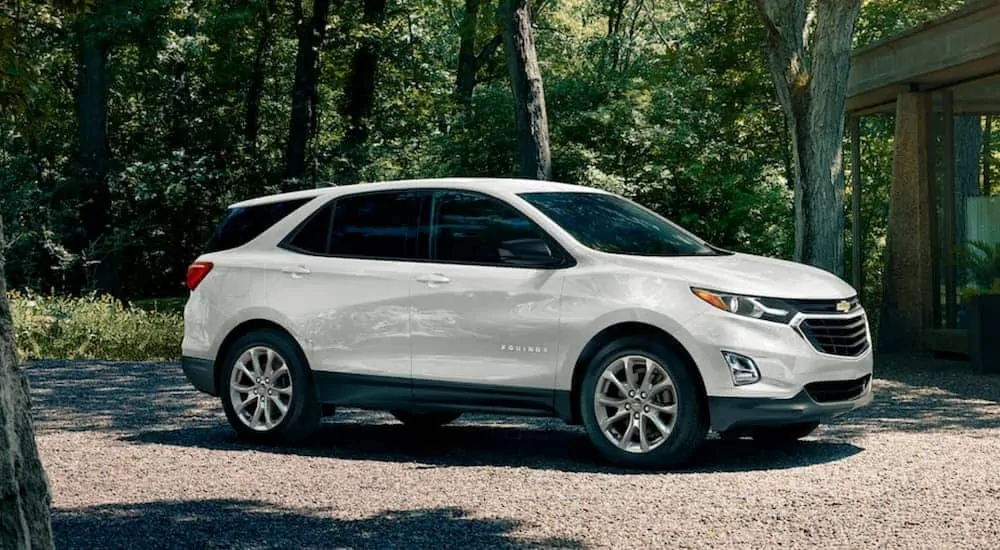 A white 2020 Chevy Equinox is parked on a gravel driveway.