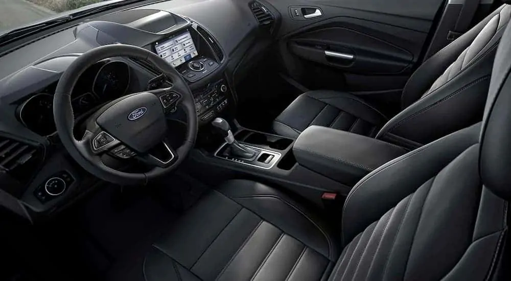 The black interior and infotainment features of the 2019 Ford Escape are shown.