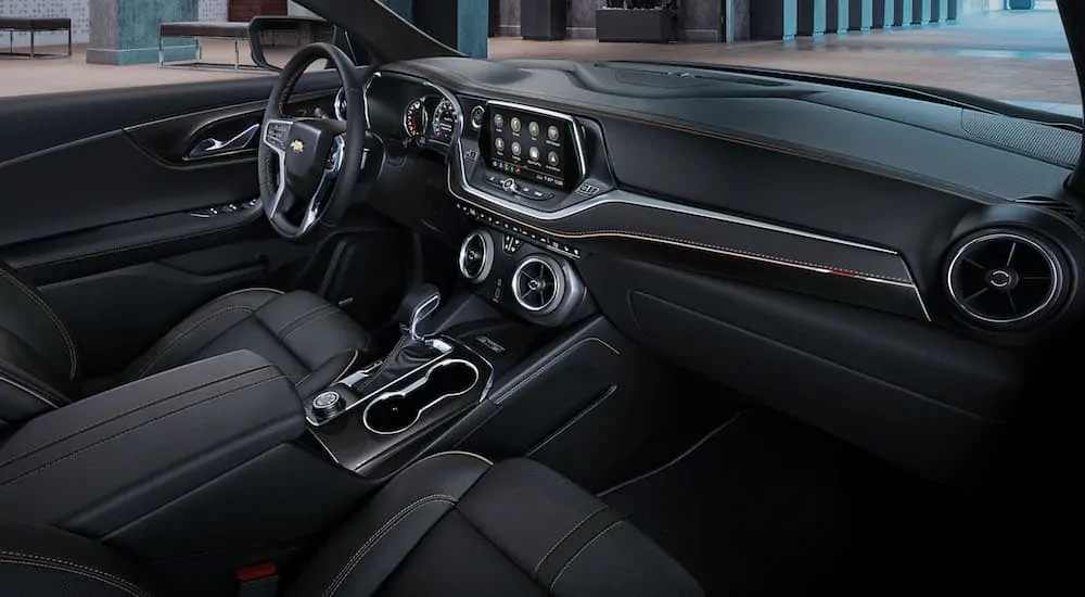 The front black interior of a 2020 Chevy Blazer 1LT is shown with an infotainment system.