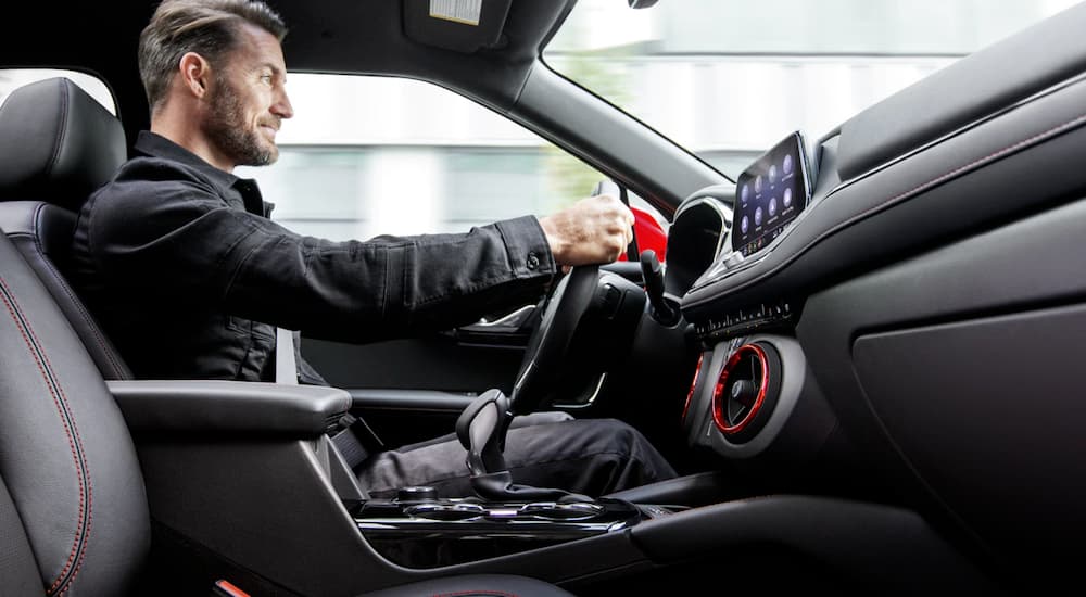 A man is shown driving his 2020 Chevy Blazer with an interior view.