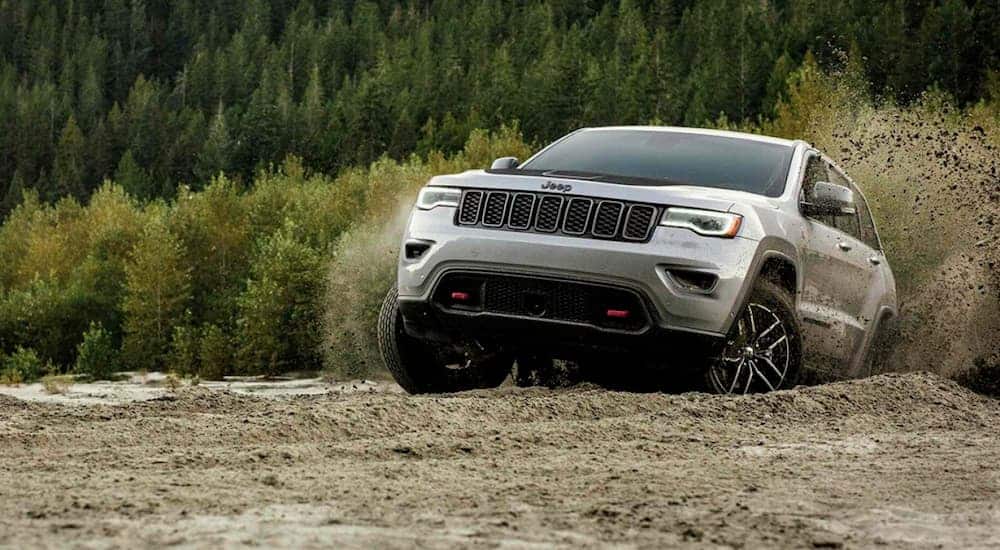 A silver 2019 Jeep Grand Cherokee Trailhawk is off-roading.