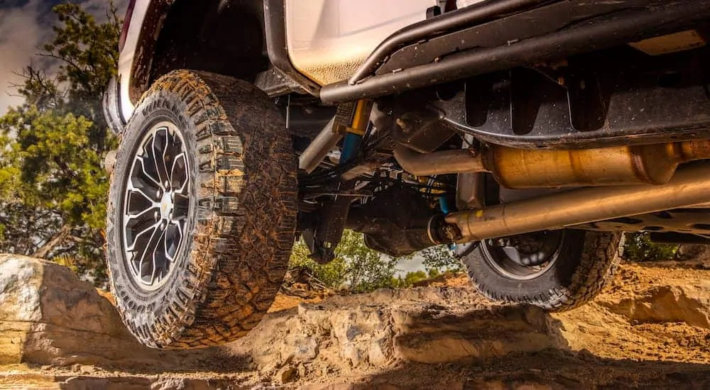 A 2018 Chevy Colorado is off-roading with upgraded wheels and off-road tires, which is a popular upgrade option among used trucks for sale.