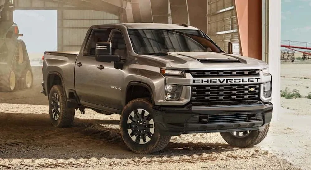 A brown 2020 Chevy Silverado 2500HD Custom is parked inside of a barn. 