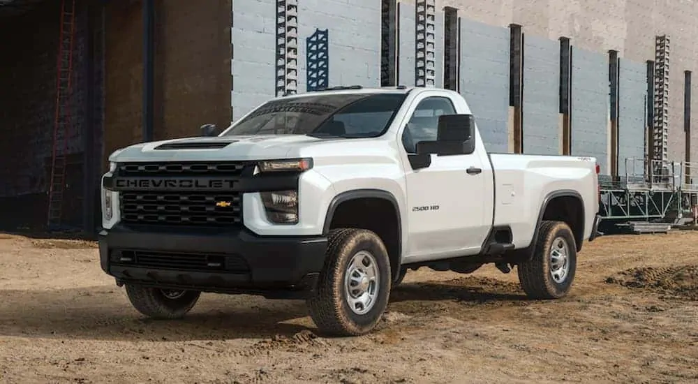 A white 2020 Chevy Silverado 2500HD Work Truck is parked at a construction site. 