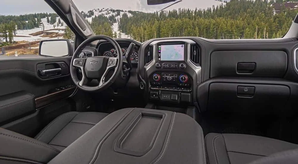 The front black leather interior of a 2020 Chevy Silverado 1500 is shown. 