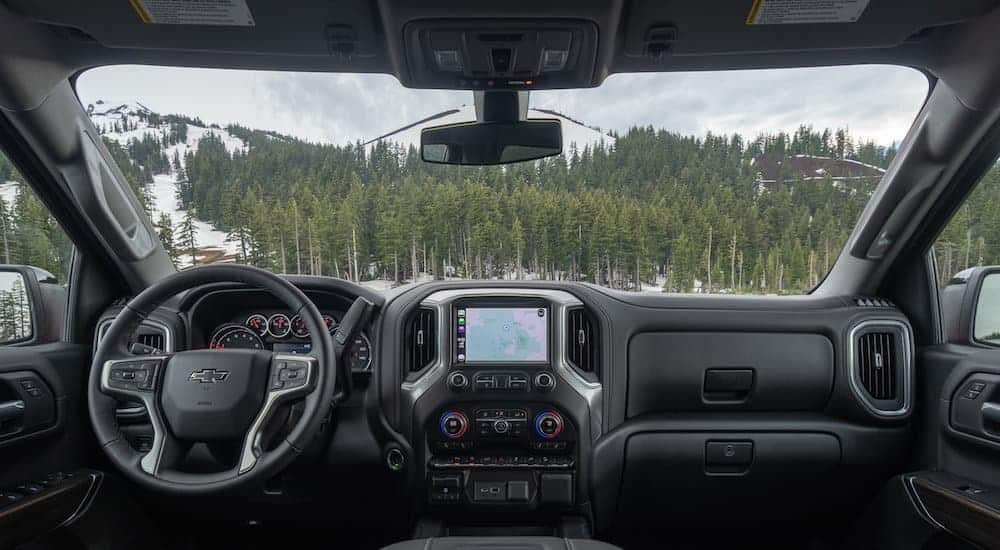 The front black leather interior of a 2020 Chevy Silverado 1500 is shown.
