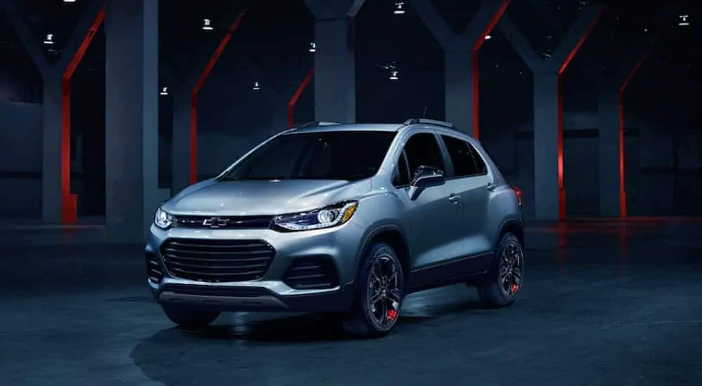 A silver 2020 Chevy Trax Redline Edition is parked in a dark lit garage.