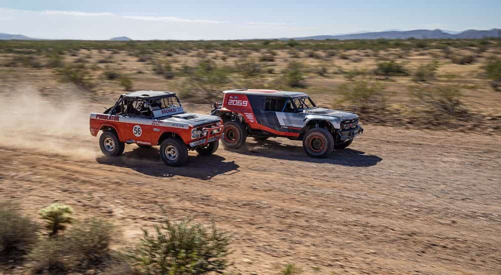 A 2020 Ford Bronco R Race Prototype and 1969 Baja 1000 are racing in the desert.