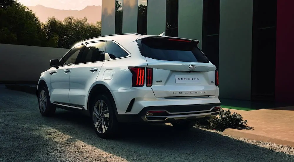 A white 2021 Kia Sorento facing away in an upscale driveway