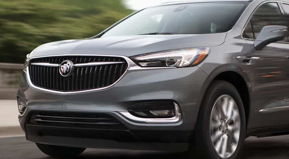 A close up of the front end of a 2020 Buick Enclave as it's driving on a highway is shown. 