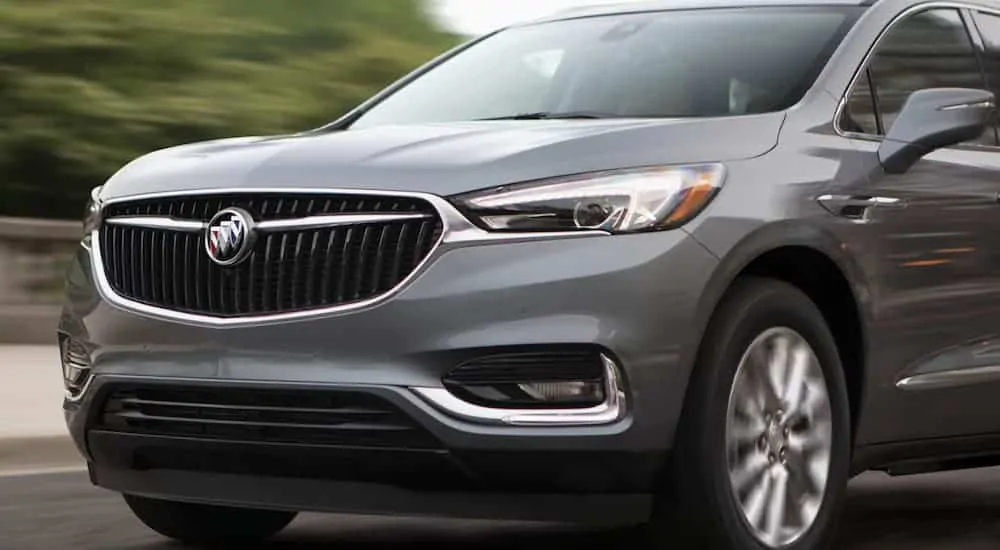 A close up of the front end of a 2020 Buick Enclave as it's driving on a highway is shown. 