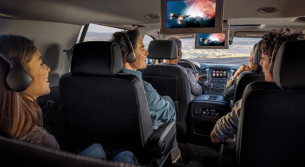 A family is watching movies in the 2020 Chevy Suburban in the back two rows.