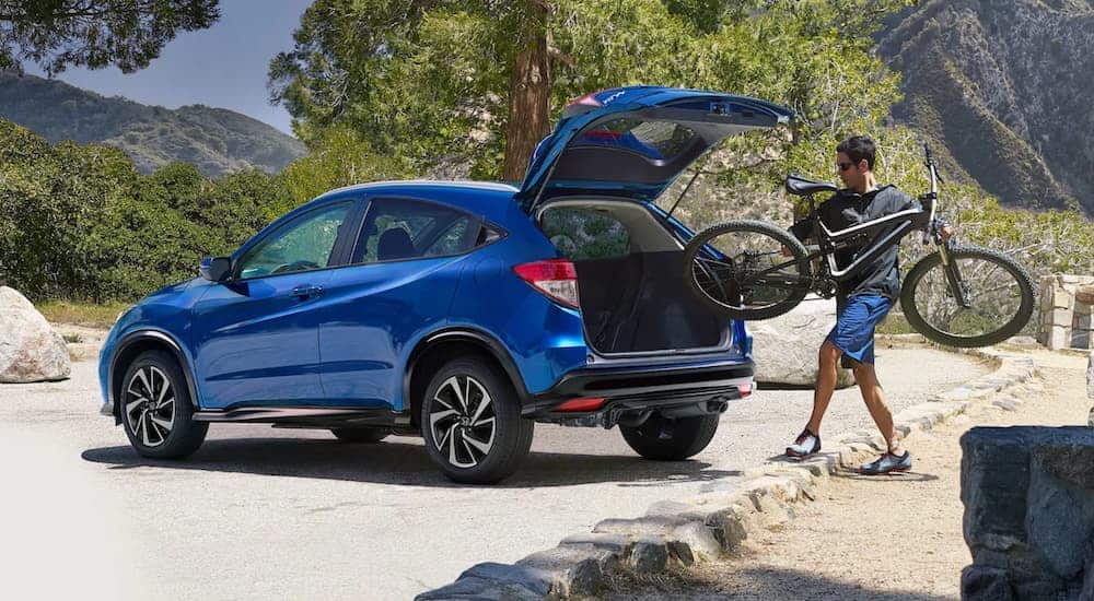 A man is loading his bike into the back of a 2020 Honda HR-V.
