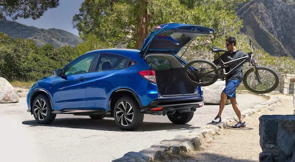 A man is loading his bike into the back of a 2020 Honda HR-V.
