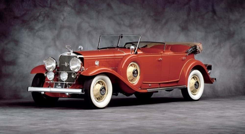 A classic used Cadillac, a red 1931 Cadillac V16 in a gray showroom
