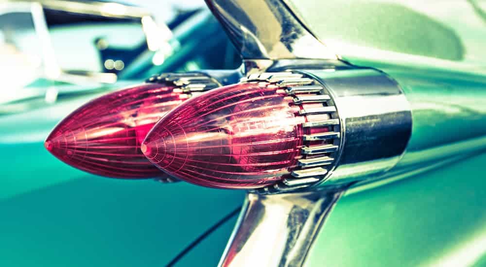 A closeup of the pointed taillights on a green 1959 Cadillac DeVille