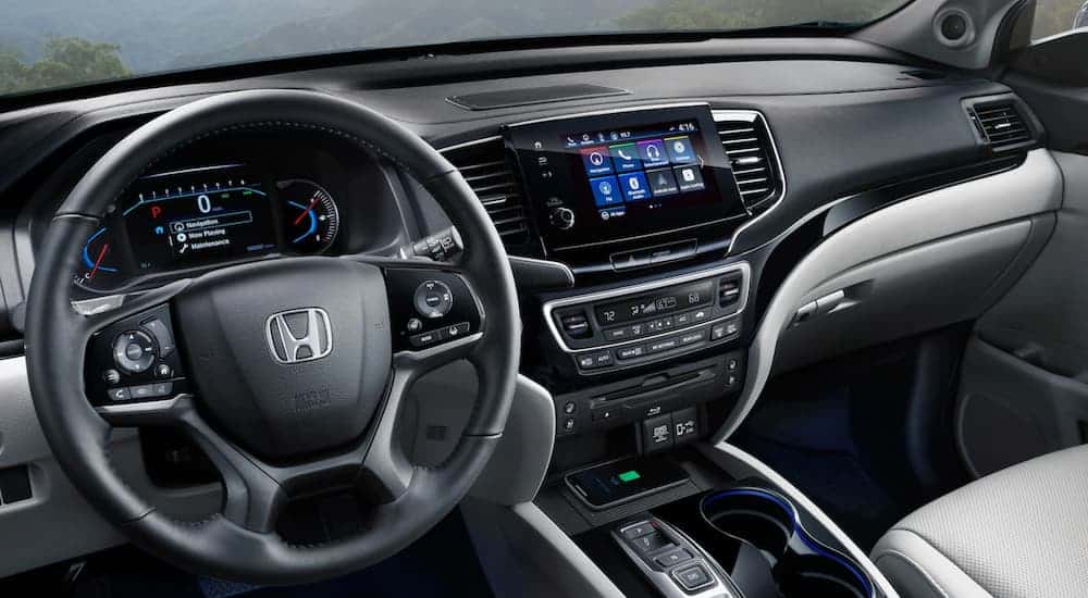 The black dashboard and infotainment screen on a 2020 Honda Pilot are shown.