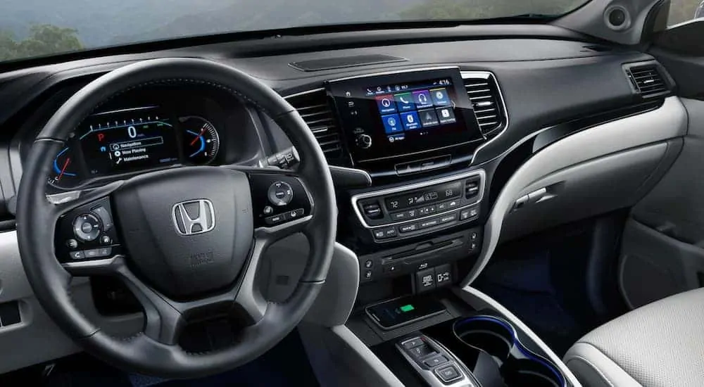 The black dashboard and infotainment screen on a 2020 Honda Pilot are shown.