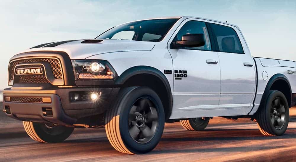 A white 2020 Ram 1500 Classic is driving on the highway.