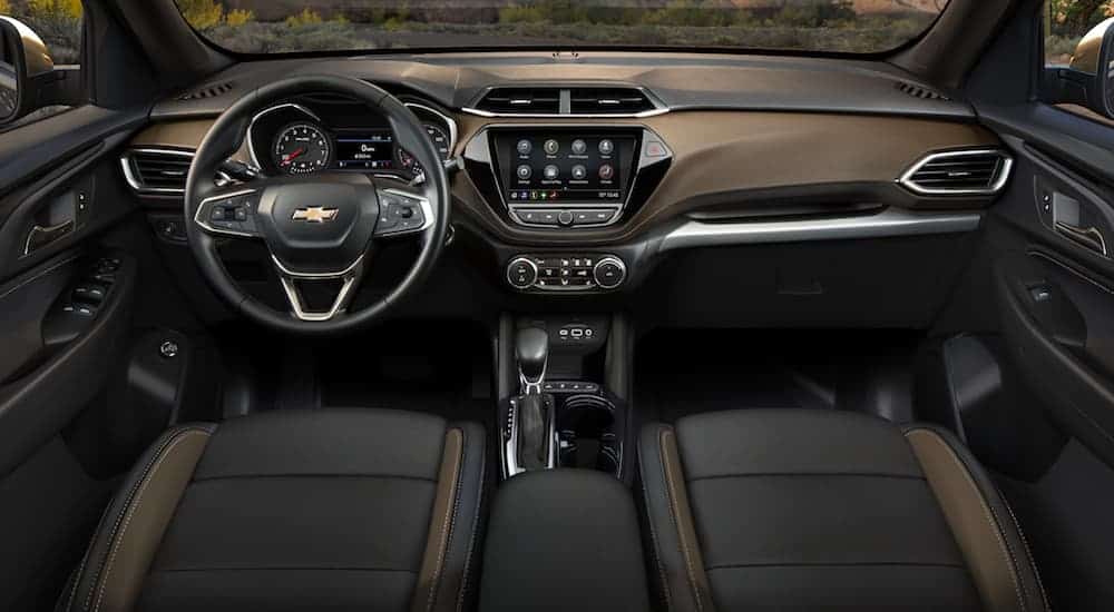 The front brown and black leather interior of a 2021 Trailblazer is shown. 