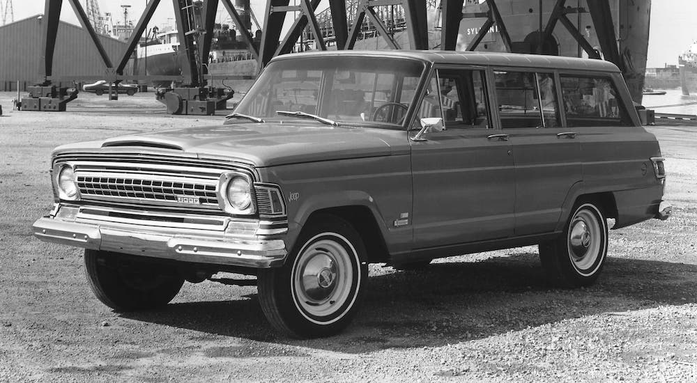 Getting ready for the 2021 Jeep Wagoneer, a black and white photo of a black 1973 Wagoneer that is parked in a shipyard.