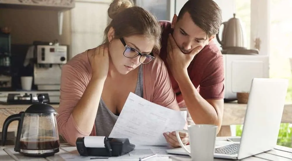 A couple is looking over their budget at home.