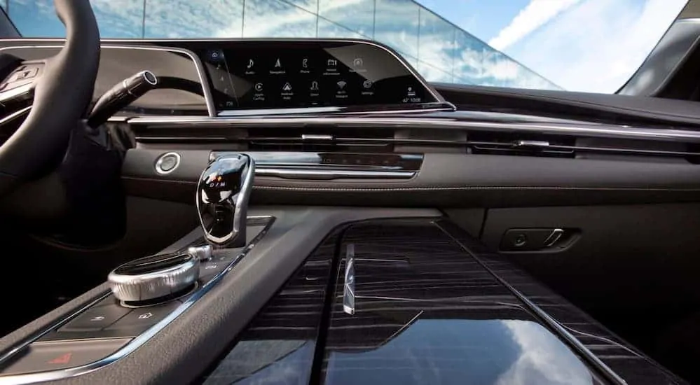 A sneak peak of the brown and grey leather interior of a 2021 Cadillac Escalade is shown.