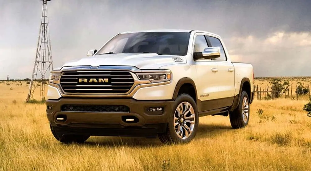 A white 2020 Ram 1500 is parked in a field.