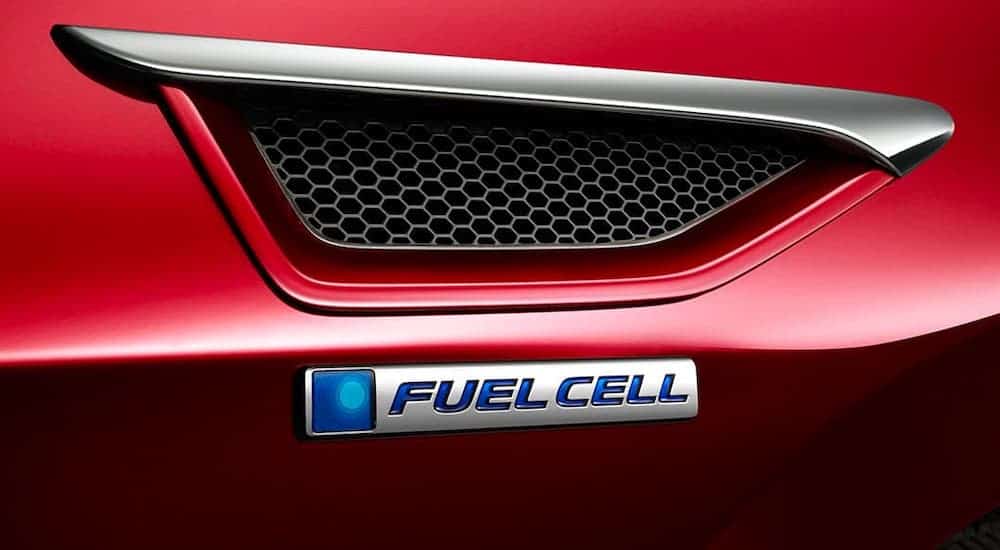 The Fuel Cell badging is shown in closeup on a red 2020 Honda Clarity.