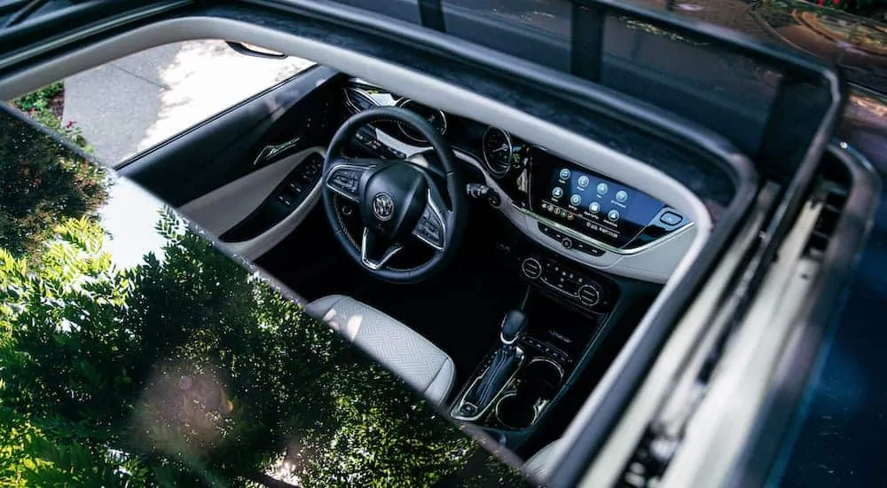 The open sunroof is shown from above on a blue 2020 Buick Encore GX.