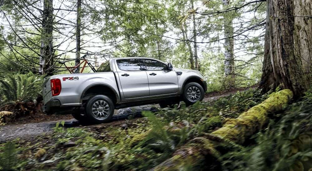 A silver 2020 Ford Ranger XLT is off-roading in the woods.