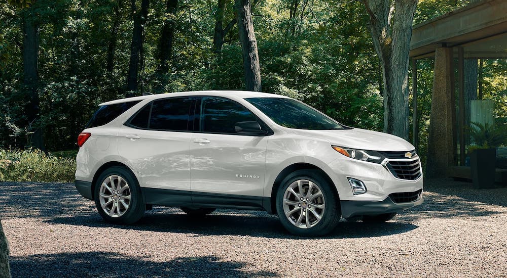 A white 2020 Chevy Equinox is parked in the woods.