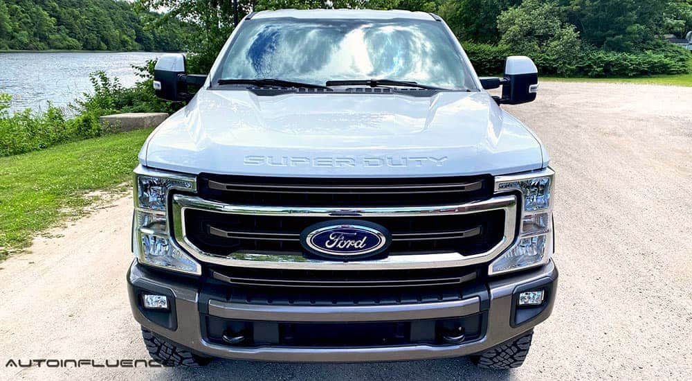 A white 2020 Ford F-250 Super Duty Tremor is shown from the front next to a river.