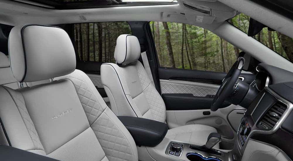 The gray and black front seats are shown in a 2020 Jeep Grand Cherokee Summit, the winner of the 2020 Jeep Grand Cherokee vs 2020 Toyota Highlander competition.