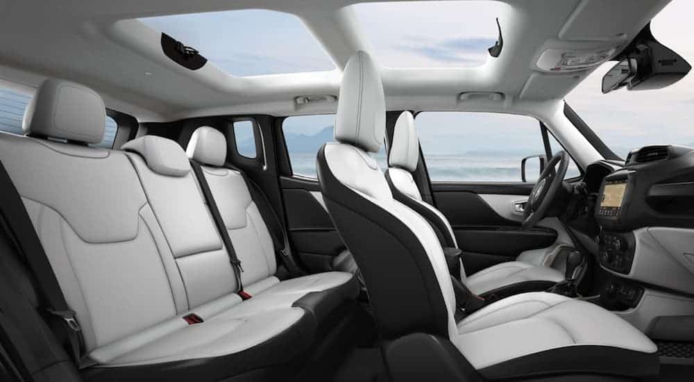 The white and black interior of a 2020 Jeep Renegade is shown from the side.