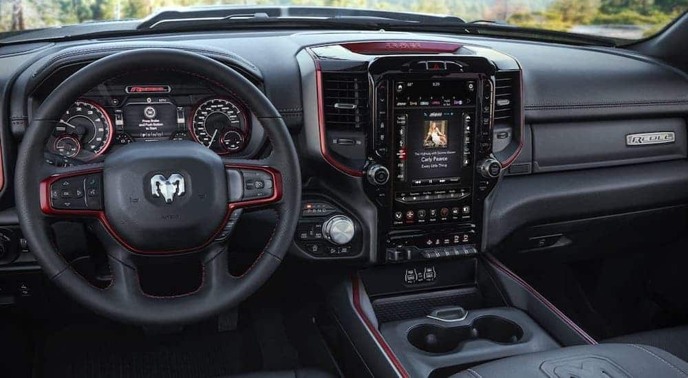 The black interior with red trim is shown in a 2020 Ram 1500 Rebel, winner of the 2020 Ram 1500 (new Ram) vs 2020 GMC Sierra 1500 comparison.