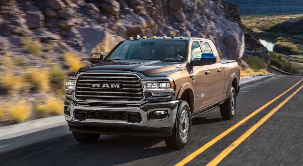 A brown 2020 Ram 2500 is driving on a highway.