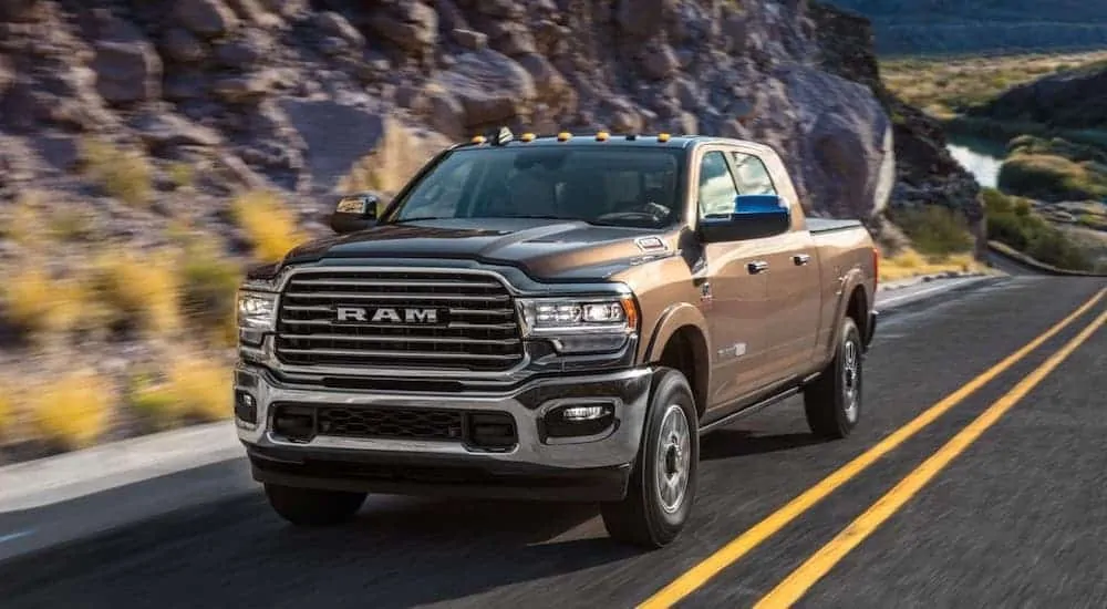 A brown 2020 Ram 2500 is driving on a highway.