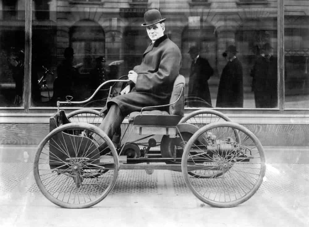 Henry Ford is riding a Quadricycle, shown in black and white.