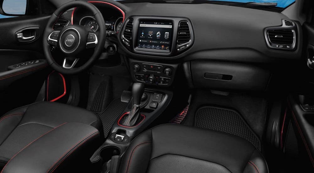 The black interior with red accents inside a 2020 Jeep Compass are shown.