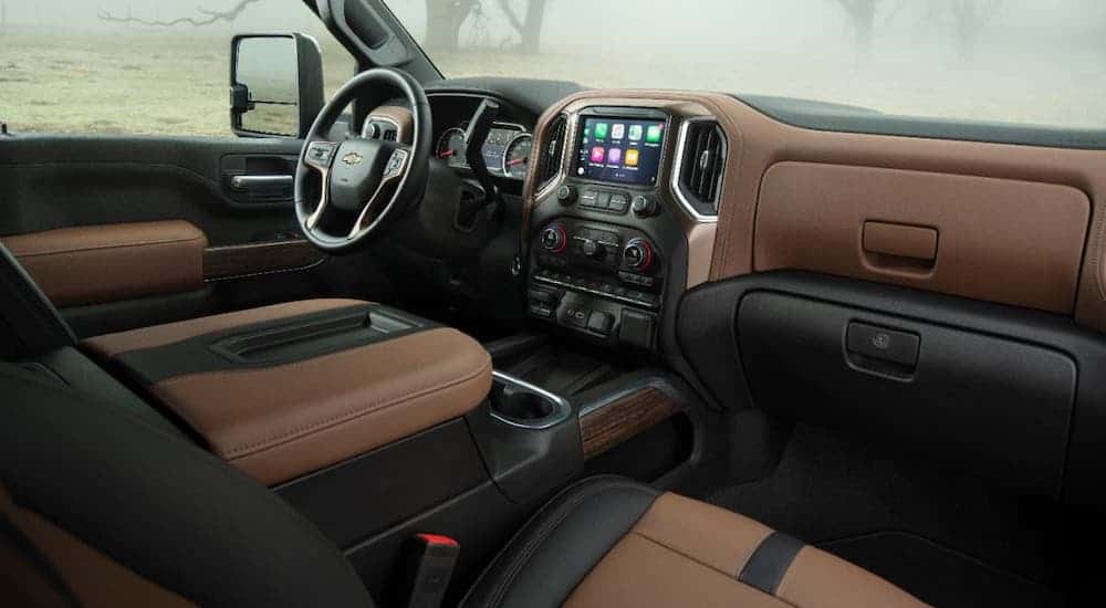 The brown and black leather interior is shown in a 2020 Chevy Silverado 2500HD High Country.