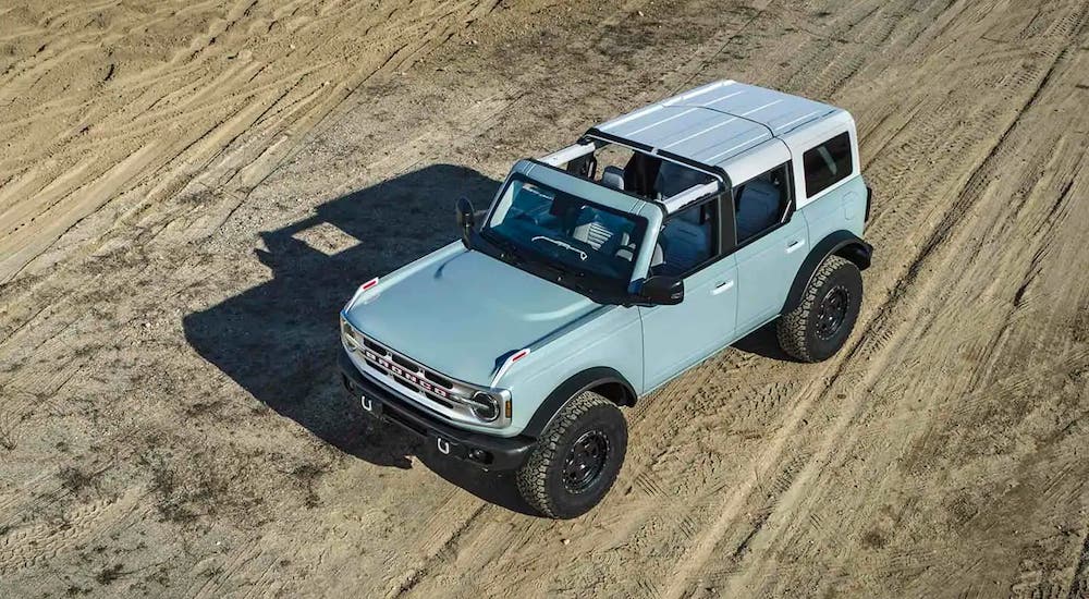 A blue 2021 Ford Bronco 4 door is shown from above with one panel of the roof missing.
