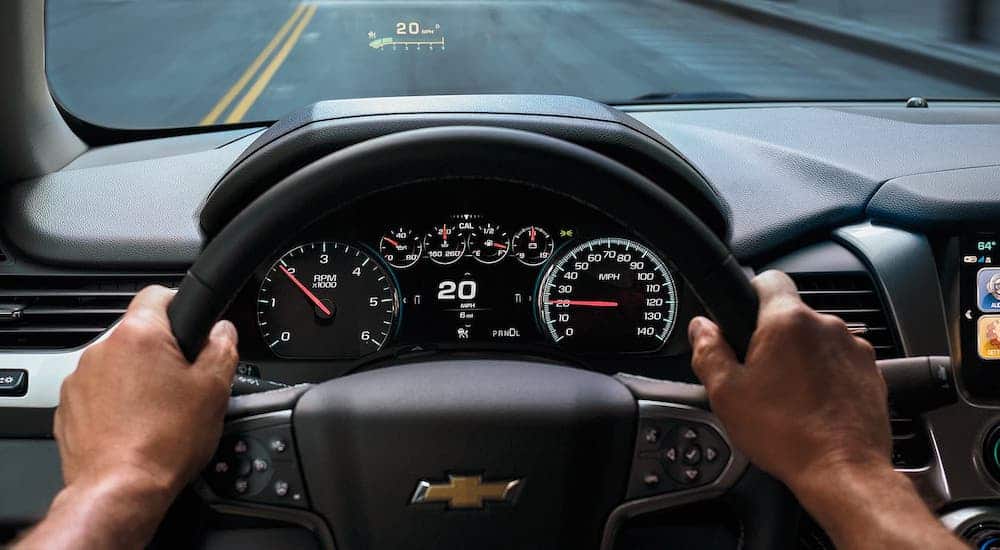 The steering wheel, driver information screen and head up display is shown in a 2020 Chevy Suburban.