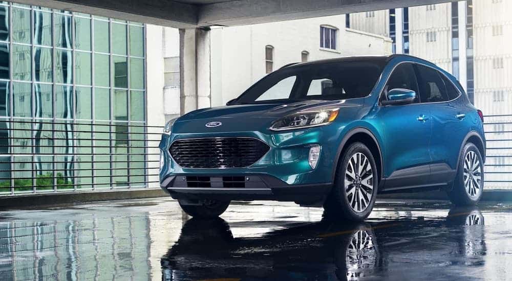 A blue 2020 Ford Escape is parked in a garage.